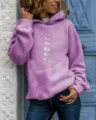 Detail shot of a women's casual purple hoodie featuring a moon phase graphic print and pocket. - Light Purple