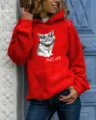 Detailed view of women's red hoodie featuring a grumpy cat graphic and text print. - Red