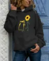 Close-up details of the women's long sleeve hooded sweatshirt with cat and sunflower graphic. - S / Tops / Black
