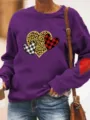 Close up detail of the purple fleece sweatshirt featuring cute heart print and sleeve patch. - Light Purple
