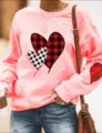Casual pink crewneck sweatshirt featuring buffalo plaid heart prints and long sleeves. - Pink