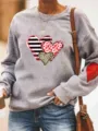 Detail view of the grey fleece sweatshirt showing heart graphic and red elbow patch details. - S / Tops / Gray