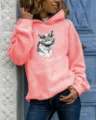 Women's long sleeve hooded sweatshirt in coral pink featuring cute grumpy cat graphic. - Pink