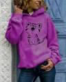 Close-up detail of the vibrant purple hoodie featuring a cute cartoon cat print, long sleeves. - S / Tops / Purple