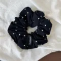 Close-up detail of a Korean style black polka dot hair scrunchie, showing soft fabric texture. - Black