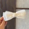 Close-up of elegant ivory lace mesh bow hair clip, delicate floral embroidery detail. - White Lace Mesh - Banana Clip