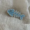 Close-up detail shot of a cute blue fish bone hair clip with star patterns for sweet hairstyles. - Ocean Series Star Fishbone Clip