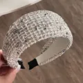 Detailed view of a chic wide tweed headband featuring a black and white mesh design. - Off White