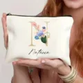 Detalle de neceser de maquillaje blanco personalizado con letra floral N y texto de nombre. - Estilo N