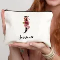 Detail shot of white canvas cosmetic pouch featuring floral letter J and custom name print. - Style 8
