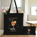 Schwarze Canvas-Tragetasche und passendes Kosmetiktäschchen mit Aperol-Spritz-Cocktail-Druck. - Schwarzes Modell 14