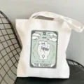 Close-up detail of a white canvas tote bag featuring a tarot card style feminist art print. - The Feminist Style / 35x40cm
