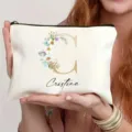 Custom canvas makeup bag with floral letter and zipper design, perfect for daily toiletry storage. - Style C