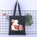 Black canvas tote bag detail showing the cute rabbit and egg print design for daily student use. - Style 18 / 35*40cm