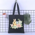 Close-up of the delicate watercolor rabbit and floral print on a durable black canvas tote bag. - Style 16 / 35*40cm
