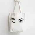 Detailed view of white canvas tote bag featuring artistic watercolor eye and floral print design. - Watercolor Flower Eye Style / 35x40cm