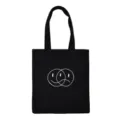 Detailed view of black canvas tote bag featuring unique overlapping facial graphic design. - Line Art Faces Style 5 / Normal Packaging / Black