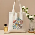 Detailed view of botanical mushroom printed canvas tote bag styled nicely with floral decor. - Colorful Plant Mushroom Print Style / L