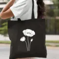 Stylish black canvas tote bag featuring minimalist white botanical print for daily use. - Line Art Floral Style / 35*40cm