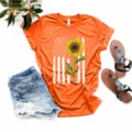 Camiseta de manga corta naranja con estampado de bandera americana y girasol casual. - Naranja