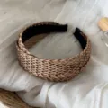 Detailed shot of a brown woven wide-brim headband, resort style hair accessory for women. - Hollow Straw Headband - Brown