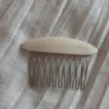 Detailed view of the elegant oval insert hair comb with acetate top bar and metal teeth. - Oval Hair Combs with Gold Label - Off-White