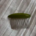 Close-up detail of green acetate side comb, featuring metal tines and glossy finish. - Gold Label Oval Hair Combs - Green
