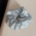 Close-up detail of the sea salt blue floral scrunchie, soft fabric with cute daisy print. - Blue Daisy Large Scrunchie