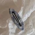 Closeup view of Korean style blue plaid hair clip and barrette for styling bangs and daily wear. - Blue Series Hollow Oval BB - Black Line Plaid
