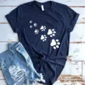 Women casual short sleeve t-shirt featuring cute cat paw print design on dark blue fabric. - Navy Blue (White Paw Print)