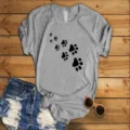 Casual grey short sleeve t-shirt for women featuring cute black animal paw print graphic. - Gray (Black Paw Print)