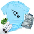 Casual women's short sleeve t-shirt featuring cute black cat paw prints, light blue top. - Sky Blue (Black Paw Print)