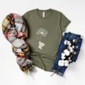 Olive green short sleeve t-shirt detail featuring cute elephant dandelion graphic flat lay - Army Green