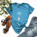 Detail view of heather blue short sleeve t-shirt featuring cute elephant and dandelion print. - Royal Blue