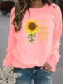 Vue détaillée du sweat-shirt graphique rose avec impression de tournesol et de citation. - Rose