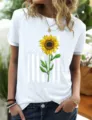 Detail shot of a white short sleeve t-shirt featuring a sunflower and distressed flag print. - White