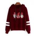 Close-up view of the Christmas gnome graphic and sleeve stripes detail on the burgundy hoodie. - Burgundy