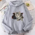 Close-up detail of grey hoodie featuring a 3D cat print, cozy long sleeves and adjustable hood. - XS / Tops / Gray