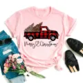 Detailed view of a pink short sleeve t-shirt featuring a festive red plaid truck graphic. - S / Top (Pink Plaid Truck-BT8528-f) / Pink