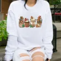 Detailed view of Christmas gingerbread print on this white casual crewneck long sleeve sweatshirt. - White