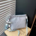 Light blue star print crossbody bag with silver star charm and stylish casual design. - Blue