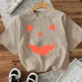 Casual beige short sleeve t-shirt featuring a fun Halloween pumpkin face print for women. - Apricot
