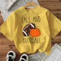 Casual yellow short sleeve t-shirt featuring fall football and pumpkin print for women. - Yellow