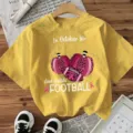 Yellow short sleeve t-shirt with football and pumpkin print for women, casual holiday top. - Yellow