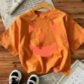 Orange Halloween short sleeve t-shirt with spooky pumpkin face print for women festive party top - Orange