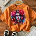 Orange short sleeve t-shirt featuring a sugar skull woman graphic print with red flowers. - Orange