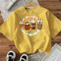 Yellow short sleeve t-shirt featuring cute autumn coffee cup graphic, casual crewneck top. - Cotton Yellow
