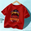 Kids Halloween red short sleeve t-shirt featuring spooky pumpkin messy bun graphic top. - 110cm / Washed Red