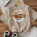 Casual beige short sleeve t-shirt featuring a cute autumn coffee cups graphic print design. - Cotton Apricot