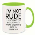 Close-up detail of a white ceramic coffee mug with bright green handle and interior quote text. - 350ml / Green